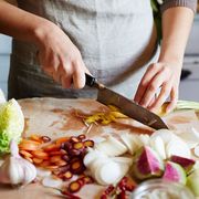 person chopping vegetables with kitchen knife