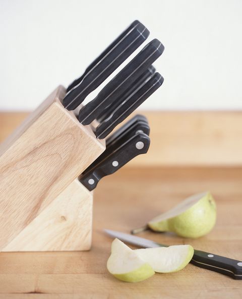Kitchen knives and sliced pear