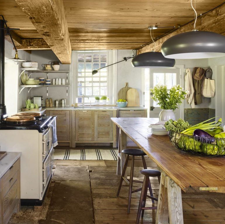 sleek and modern gray colored light fixtures decorate a very rustic kitchen