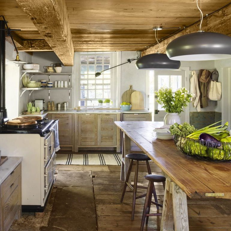 sleek and modern gray colored light fixtures decorate a very rustic kitchen
