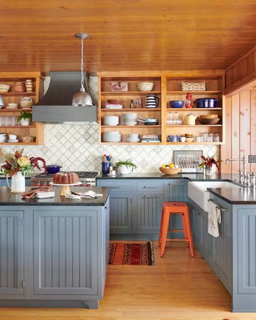 rustic kitchen with blue cabinets and open cabinetry