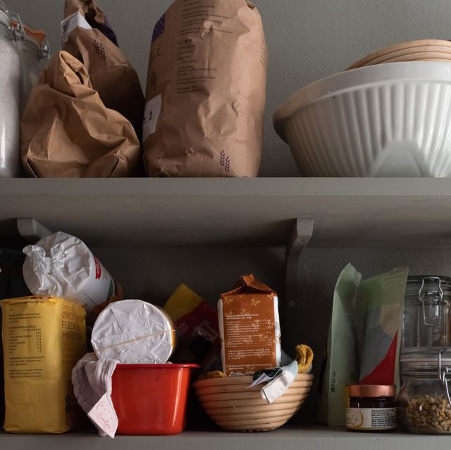 kitchen shelves with various food items in bags and jars