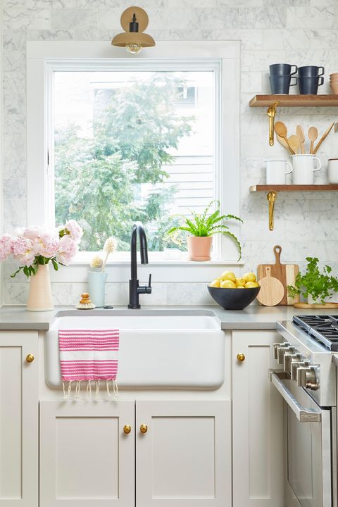 kitchen sink with white counter and bright window