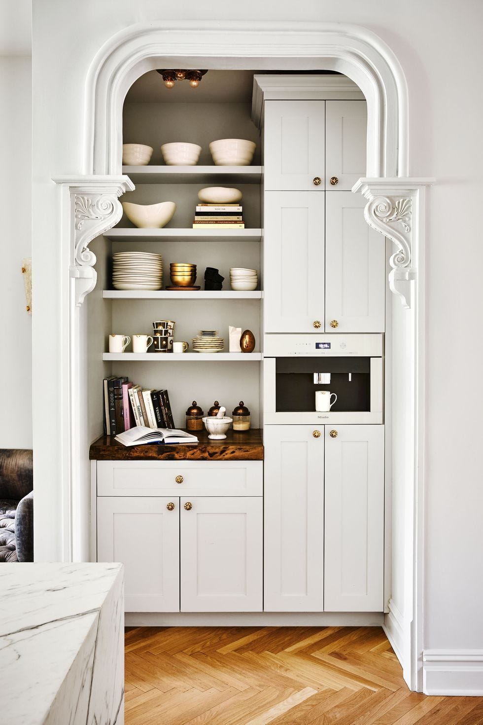 White shelving unit with white cabinets and white shelves