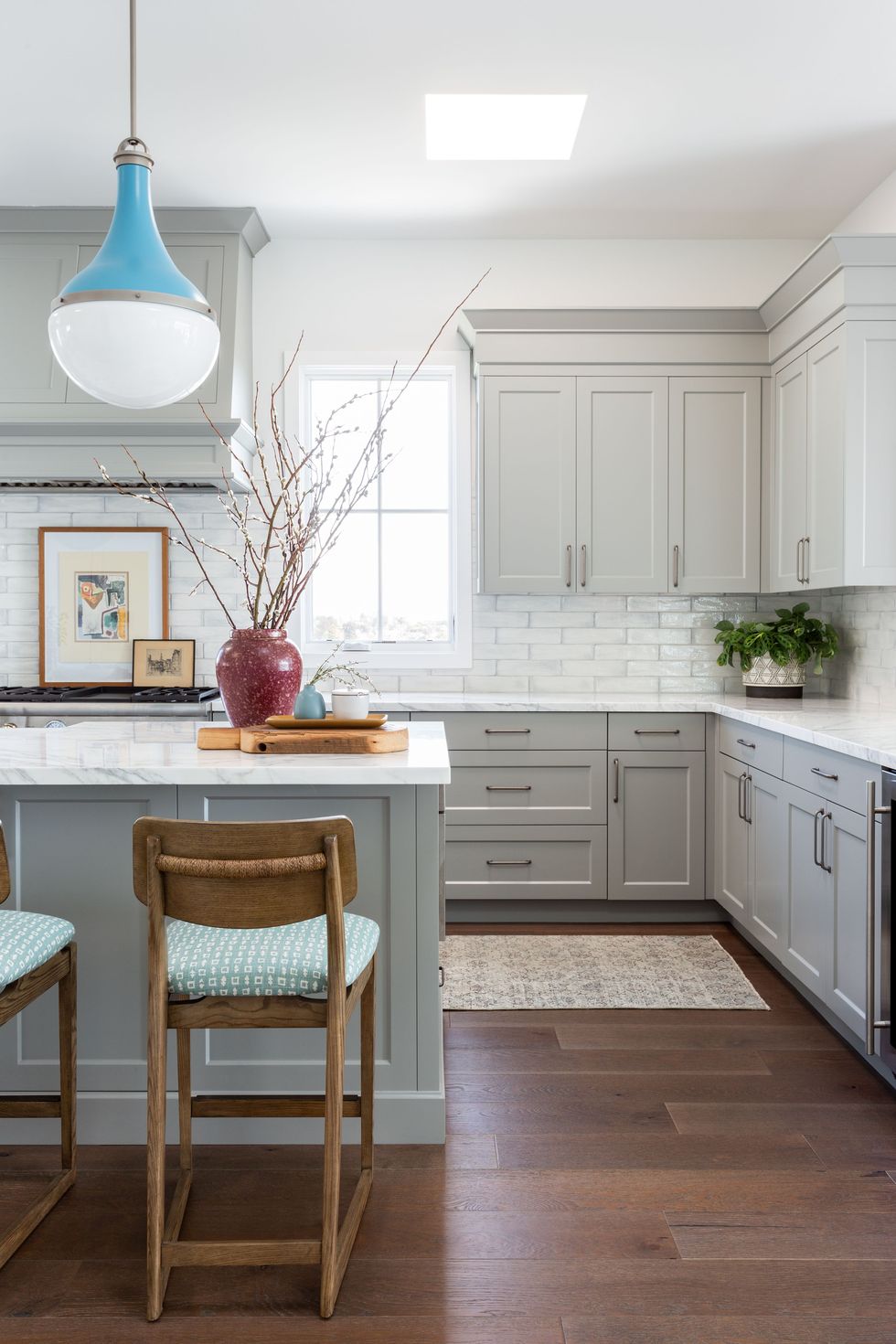 gray cabinets with bold blue pendant