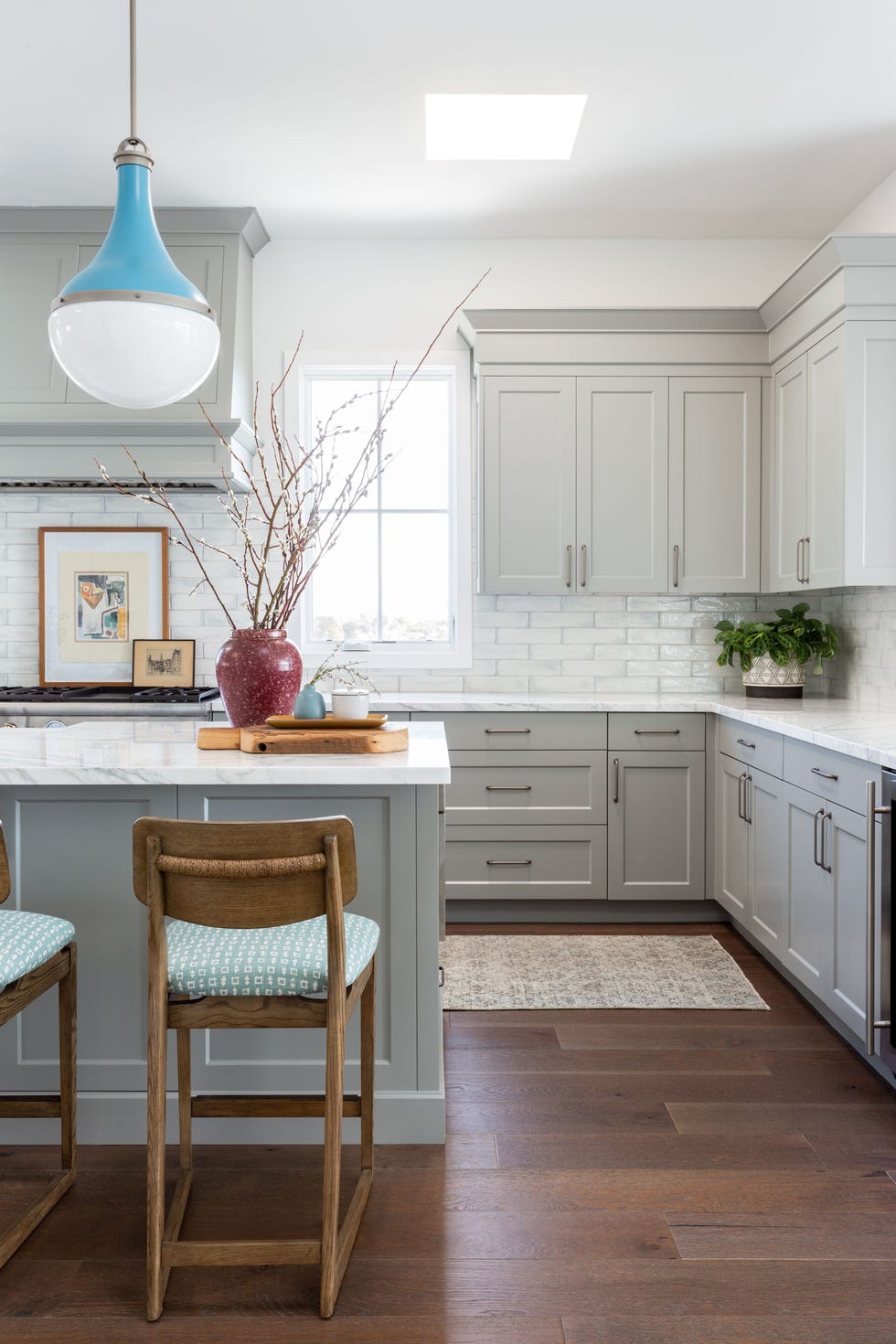 gray cabinets with bold blue pendant