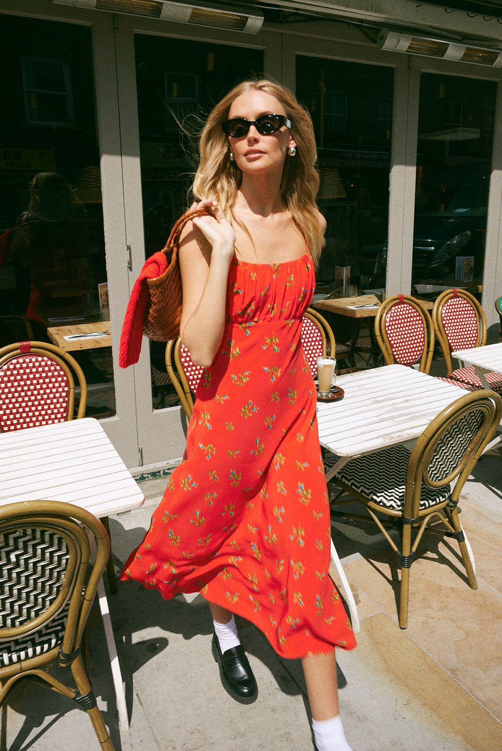 a woman wearing a red dress and sunglasses