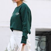 a composite image of women in comfortable street style looks including a blue sweatsuit, a cream sweatsuit, a pink hoodie with teal pants, and a green sweatshirt with white jeans and birkenstocks