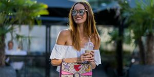 duesseldorf, germany   august 25  fashion model jueli mery drinking iced coffe on a summer evening jueli wearing white hm off shoulder top, gucci dionysus bag, zara denim shorts on august 25, 2016 in duesseldorf, germany photo by christian vieriggetty images