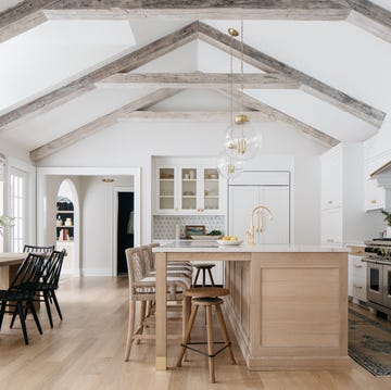 a kitchen with a chandelier and a table