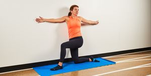 wall pilates workout a woman stretching on a mat