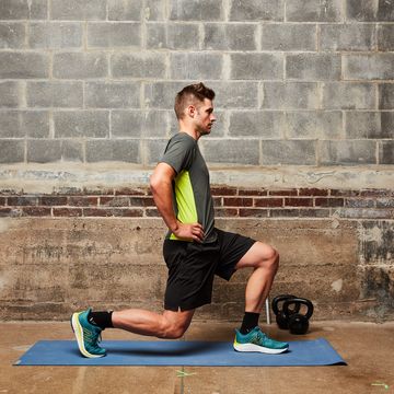a man doing a squat on a mat
