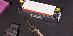 work sharp whetstone knife sharpener sitting next to a fixed blade crkt knife