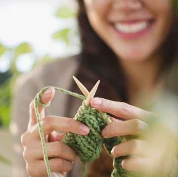 woman knitting with green yarn
