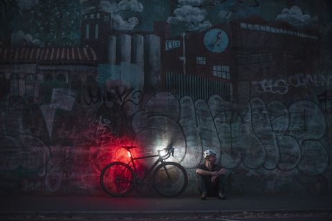 cyclist sitting next to bike with knog lights