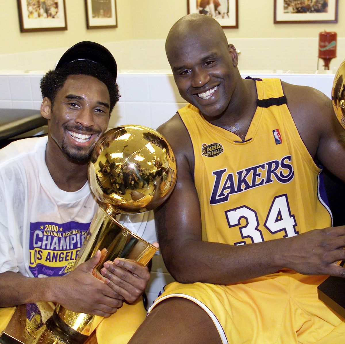 Kobe Bryant (L) of the Los Angeles Lakers holds th