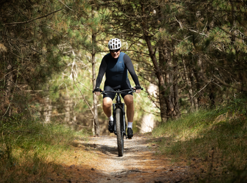 ronald koeman op de de mountainbike in het bos voor een artikel in bicycling magazine