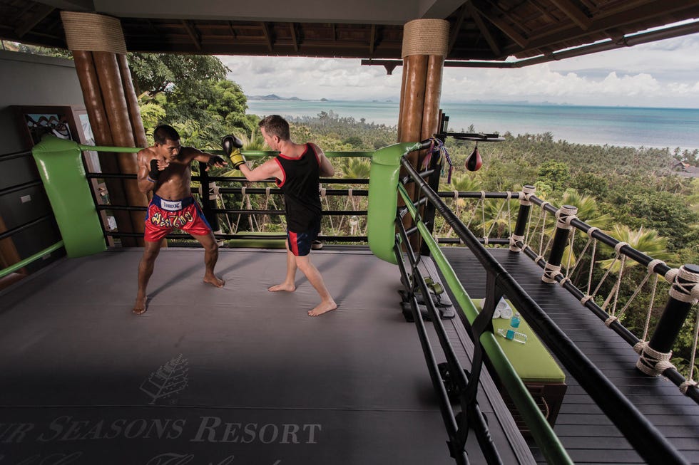 muay thai training session in an outdoor gym with ocean views