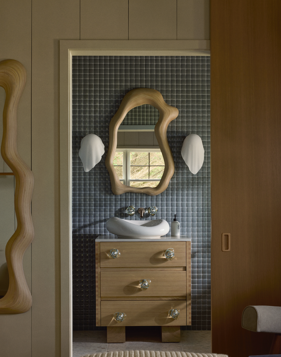 a bathroom with a mirror and sink