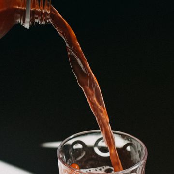 kombucha pouring in a drinking glass