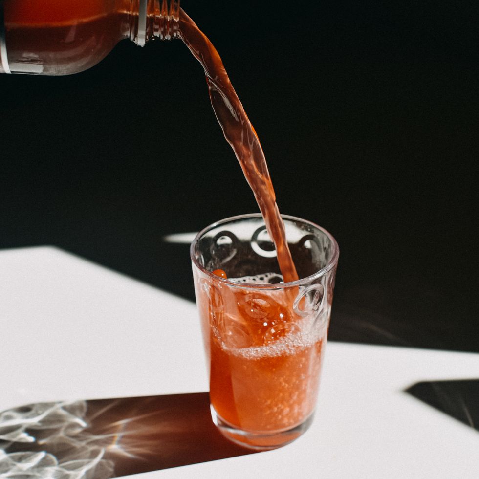 kombucha pouring in a drinking glass