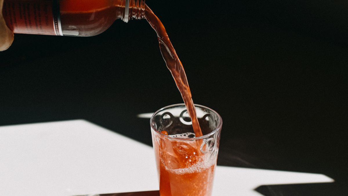 kombucha pouring in a drinking glass