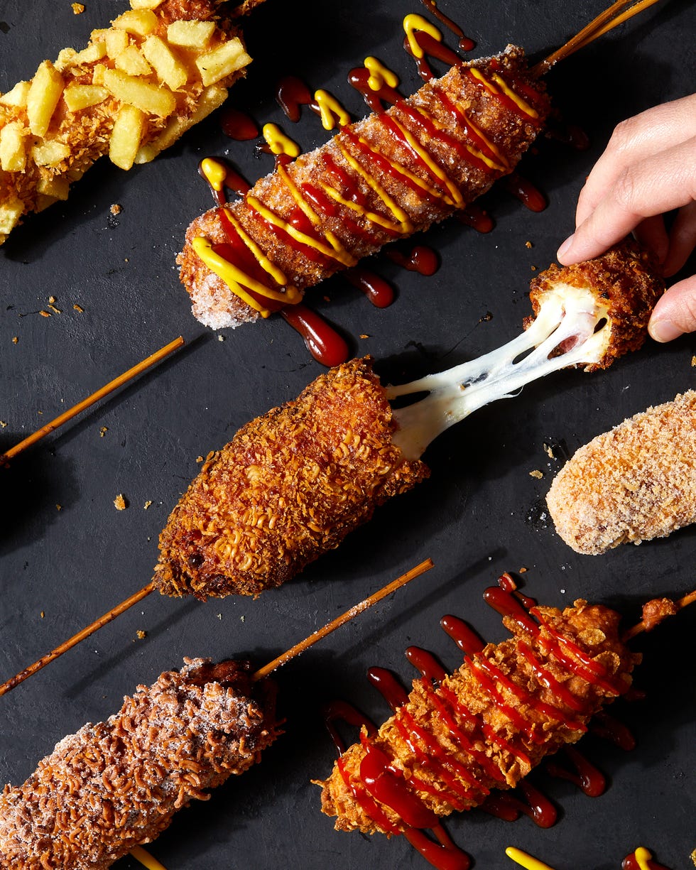 korean corn dog topped with sugar, ketchup and mustard