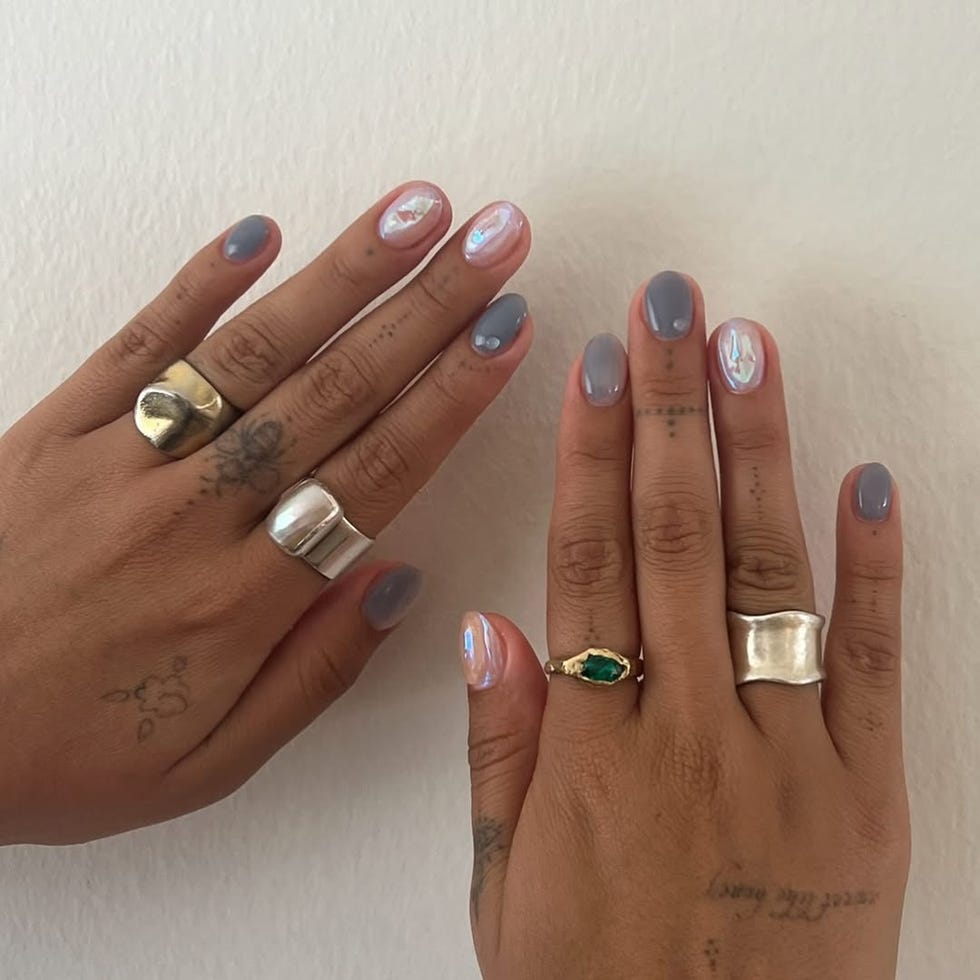 closeup of hands displaying manicured nails and various rings
