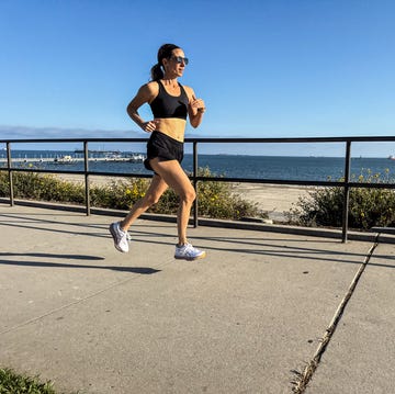 A person jogging along a waterfront path A person jogging along a waterfront path