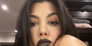 kourtney kardashian with dark purple lipstick on