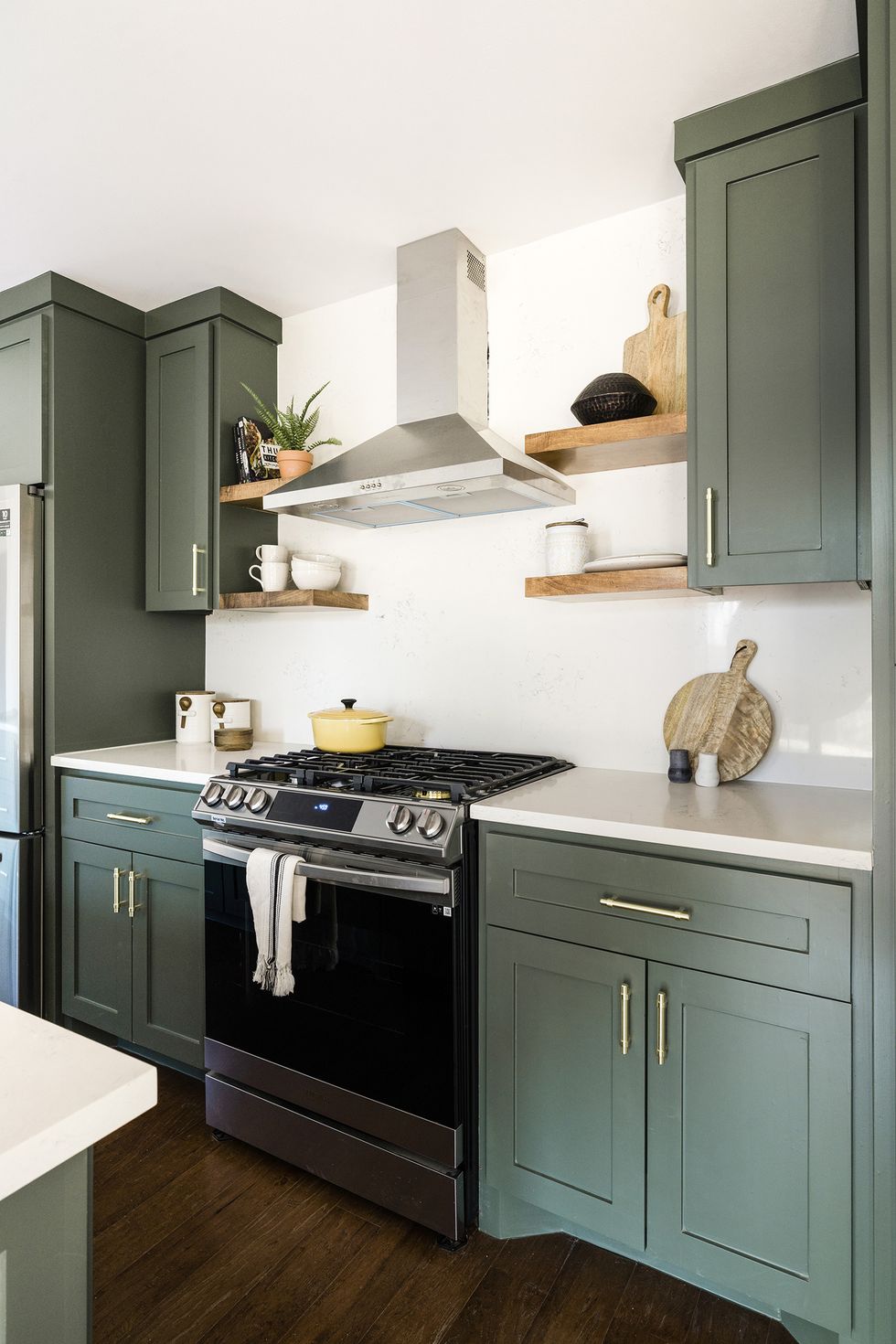 green kitchen cabinets with white counters