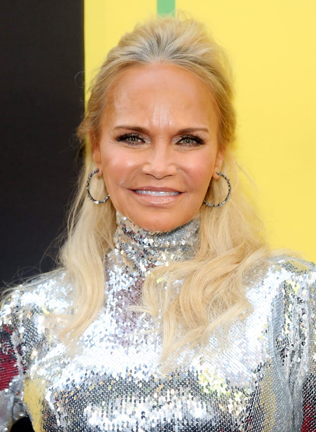 kristin chenoweth wearing a silver dress and smiling for a photograph