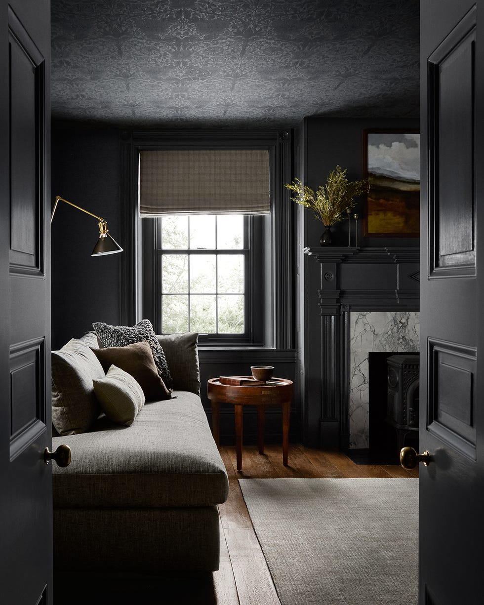 cozy living room with dark decor and a view of a window