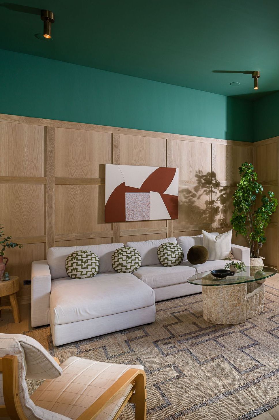 living room with green walls and wood paneling