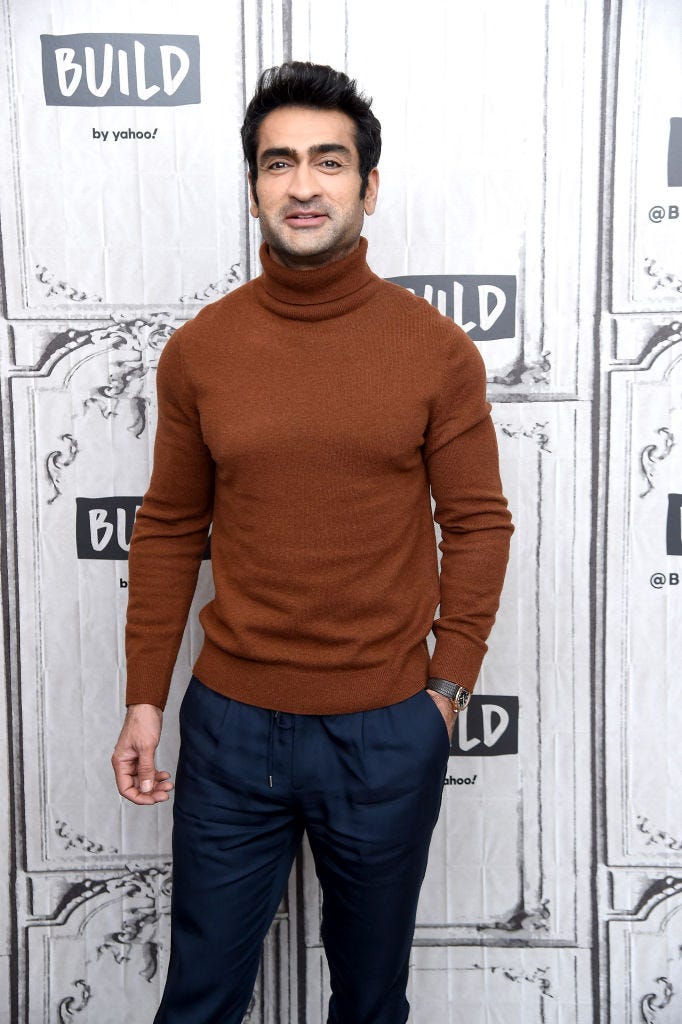 Kumail Nanjiani wears a brown turtleneck sweater on the red carpet