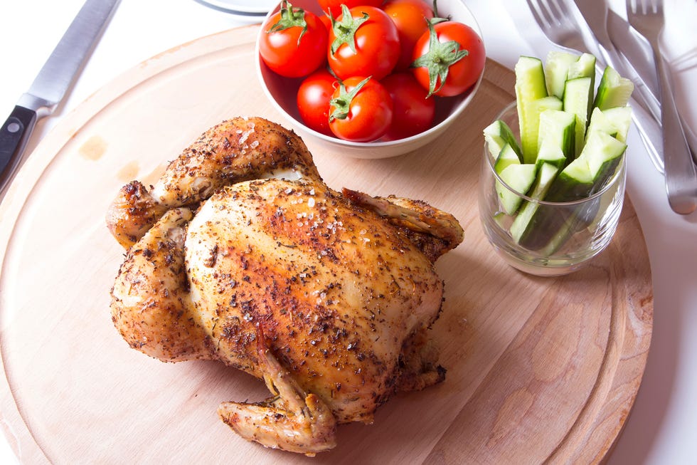 rotisserie chicken on a wooden cutting board