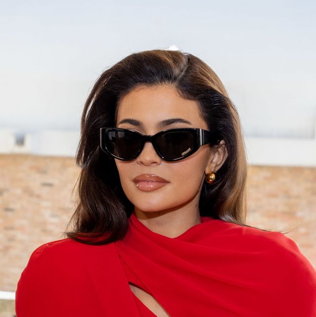 kylie jenner wearing sunglasses and a red dress