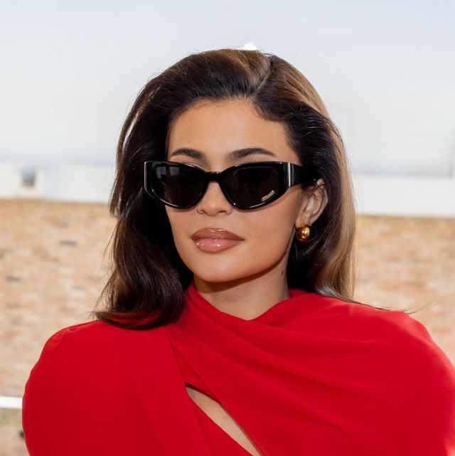 kylie jenner wearing sunglasses and a red dress