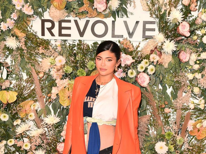 Kylie Jenner Attends NYFW Revolve Event in Orange Trench - Grazia USA