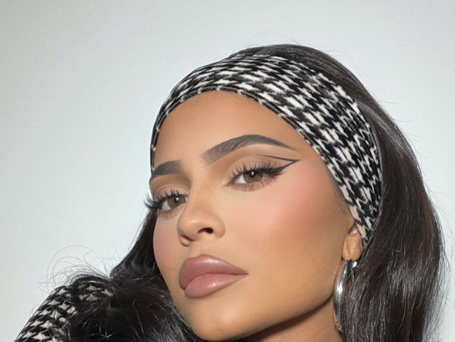 Kylie Jenner wears nude colored makeup as she models a headscarf