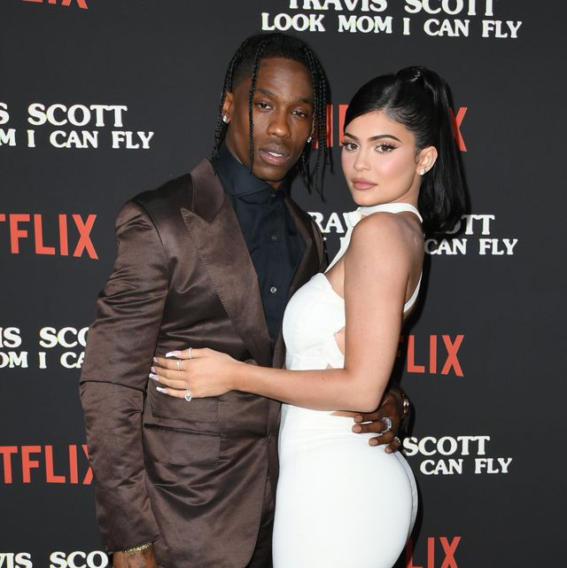 kylie jenner and travis scott posing on a netflix red carpet together
