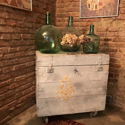 Furniture, Wall, Still life, Chest of drawers, Table, Interior design, Still life photography, Wood, Wine bottle, Bottle, 
