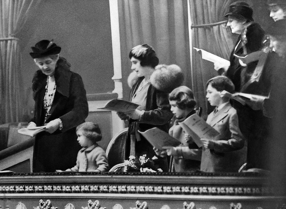 a toddler princess elizabeth sings christmas caroles with her sister, margaret, and the rest of her family