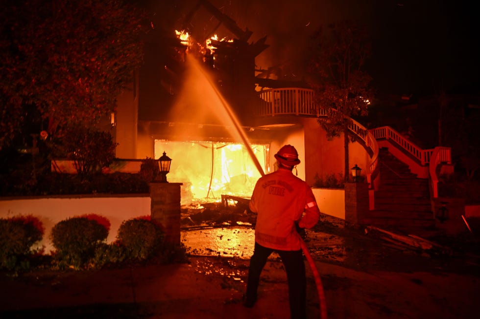 a firefighter working to extinguish one of the la fires