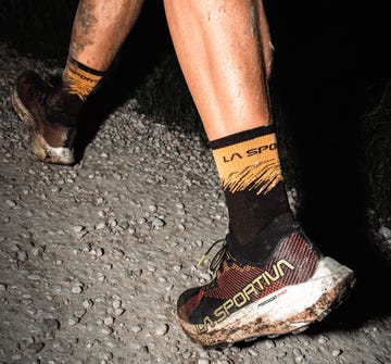 mudcovered running shoes and socks on a gravel path