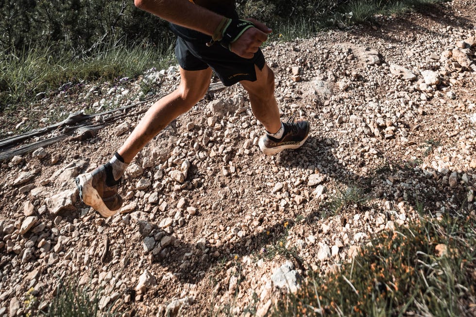 person running on a rocky trail