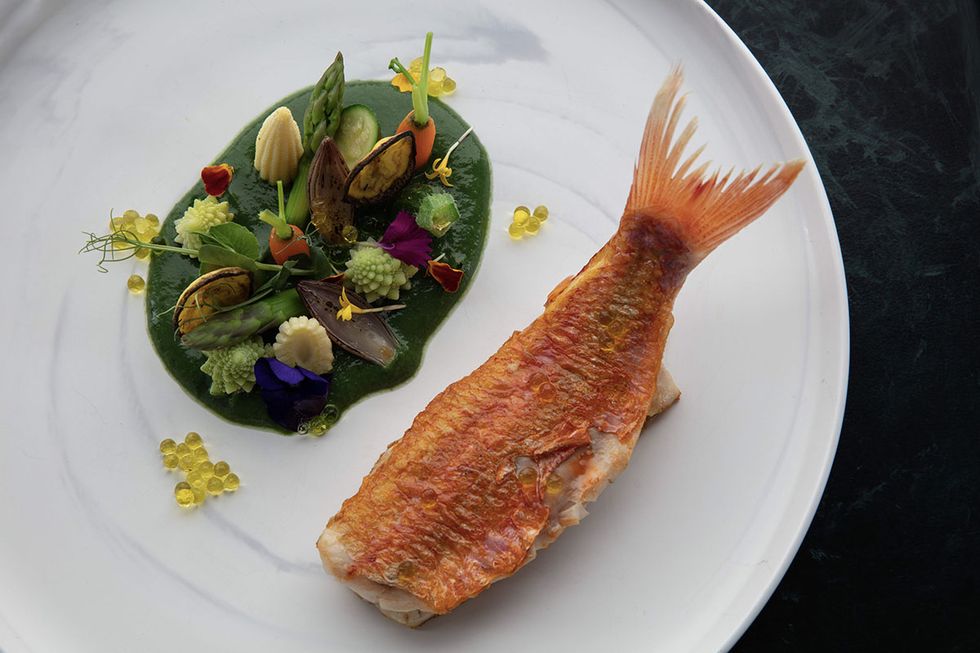 a fish on a plate with flowers