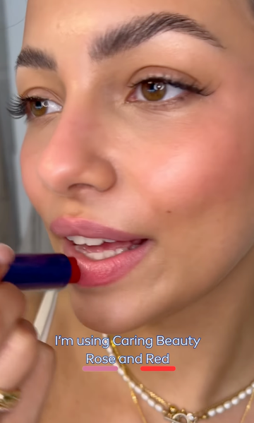 a woman with a blue nail polish