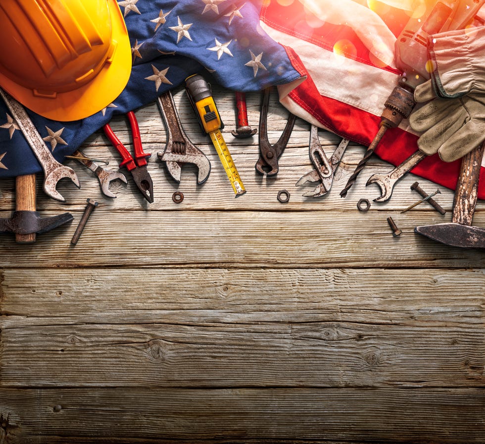 directly above shot of work tools and hardhat on american flag in family friendly labor day activities