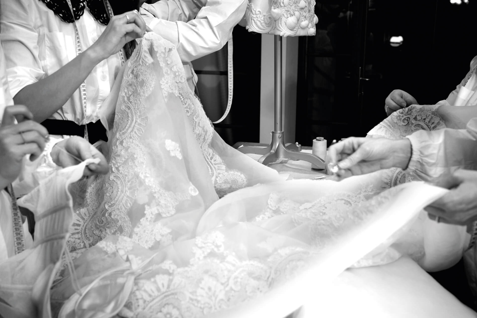 a person getting the wedding dress done
